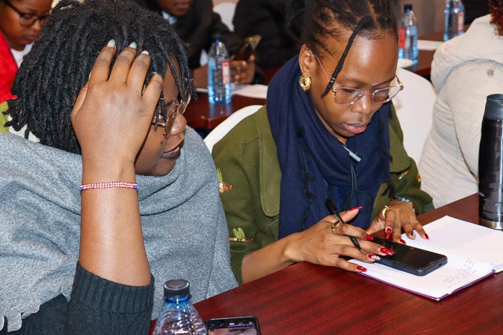 A Kenyan woman entrepreneur confidently managing her mobile money transactions securely on her smartphone.